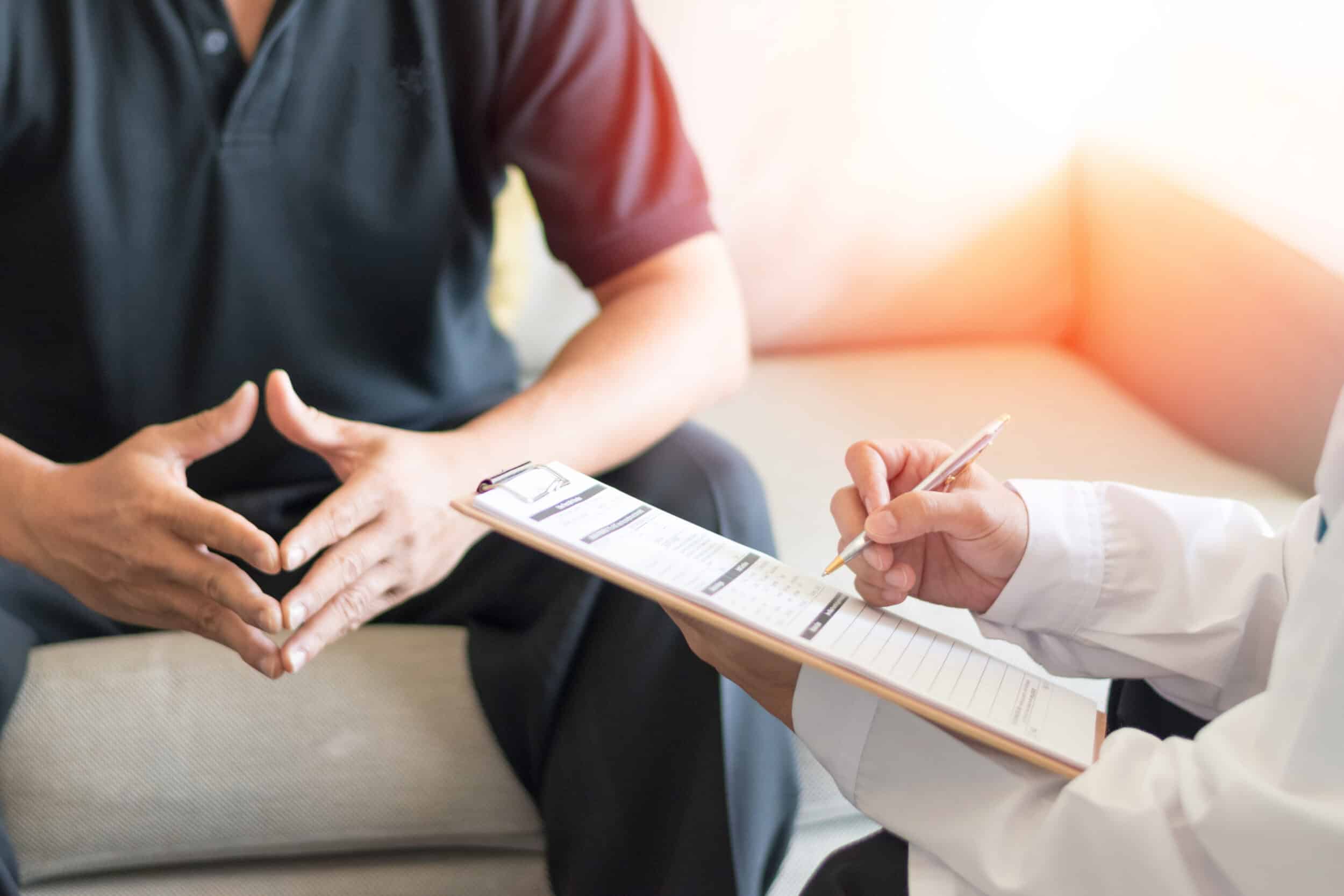 A man with Peyronie’s disease talking to a doctor