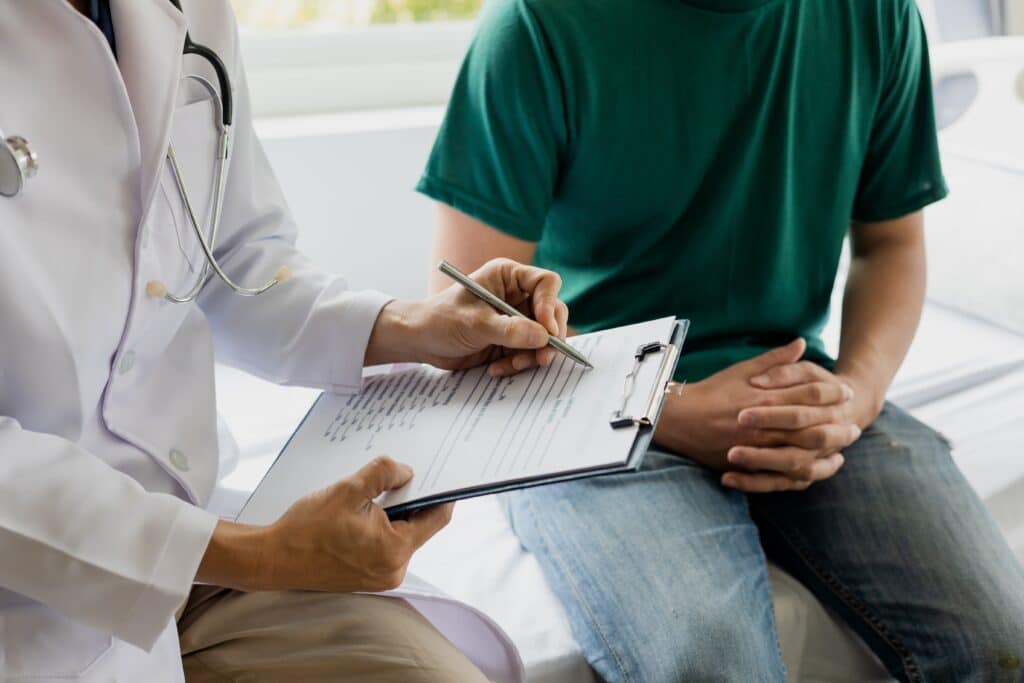 A doctor talking to a patient about Peyronie’s disease.