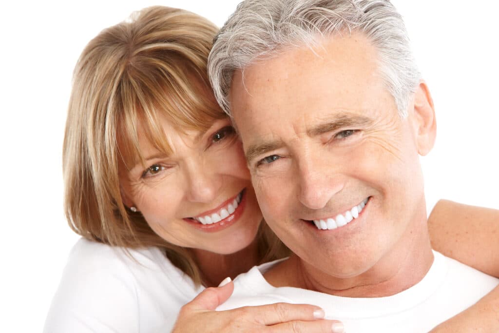 Attractive older couples smiling and cuddling