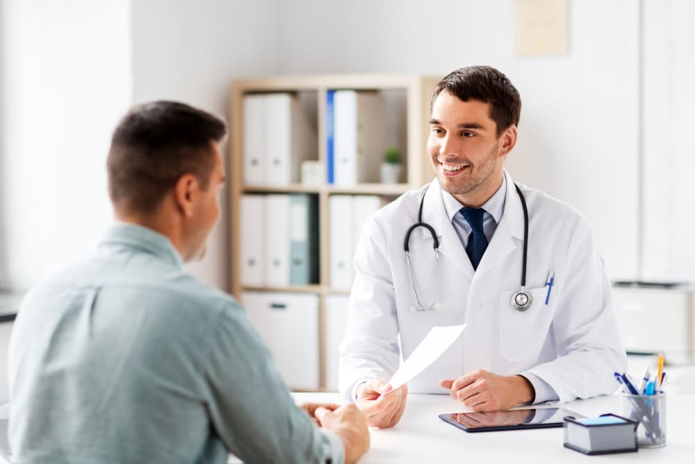 Man meeting with urologist to discuss treatments for erectile dysfunction.