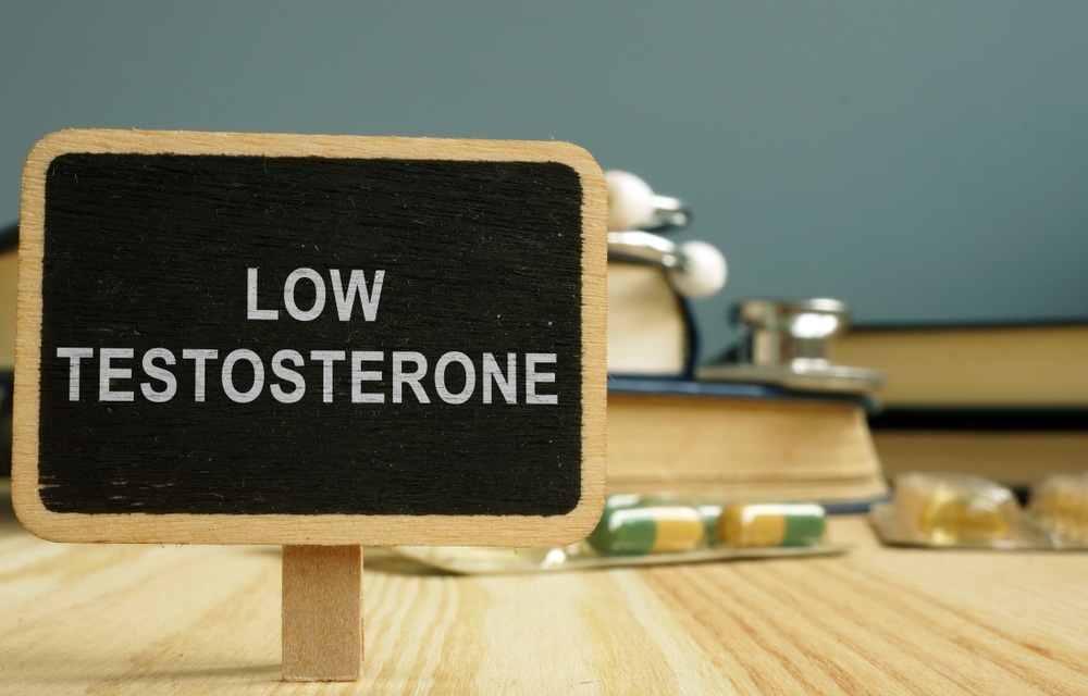 A black sign with white letters that say “Low Testosterone”