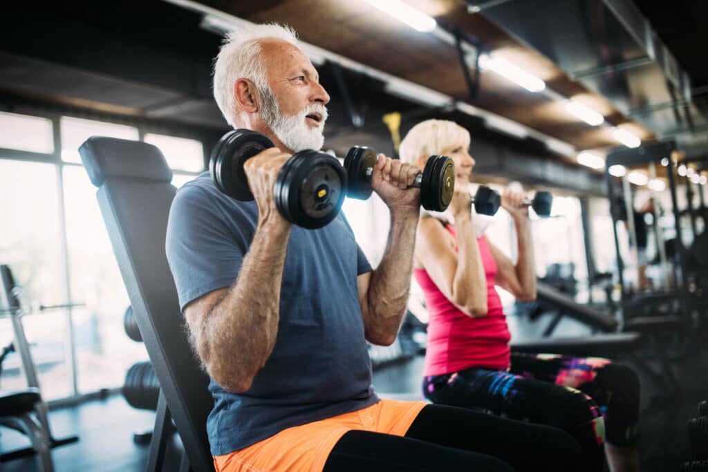 Man lifting weights in the gym to improve Shockwave Therapy for ED results